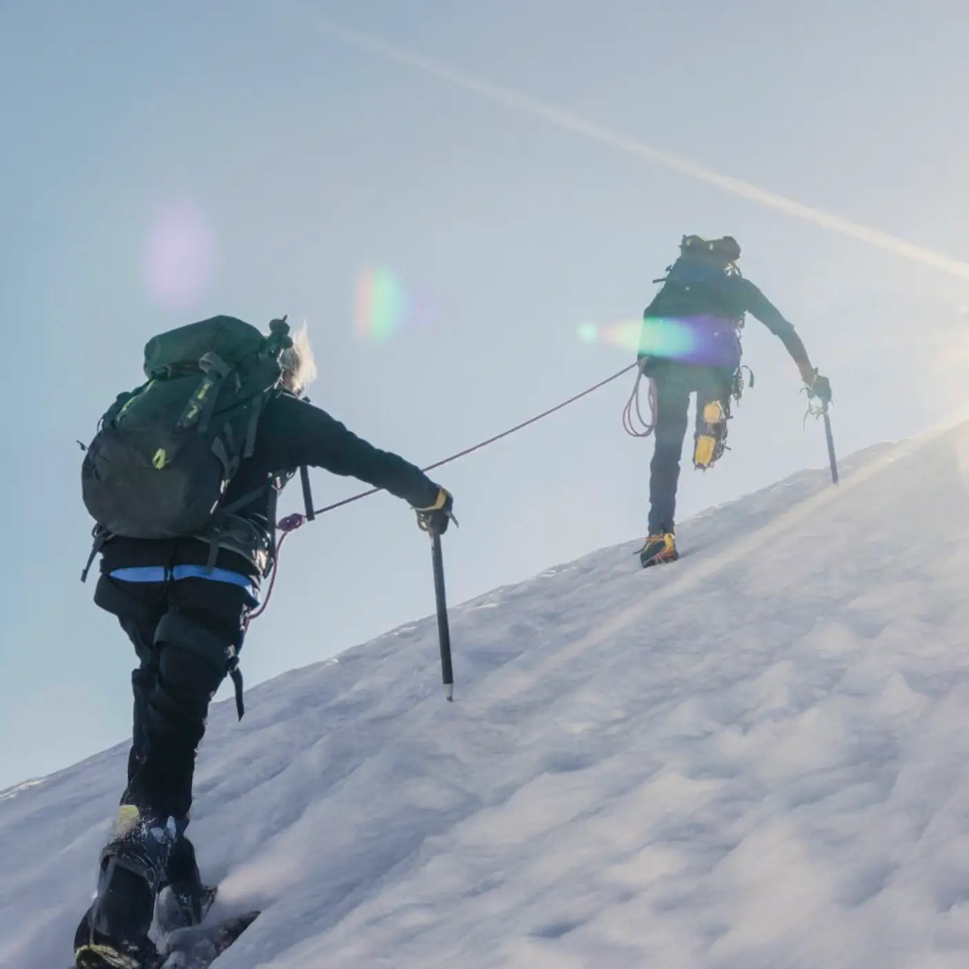 Climbers ascending a snowy mountain