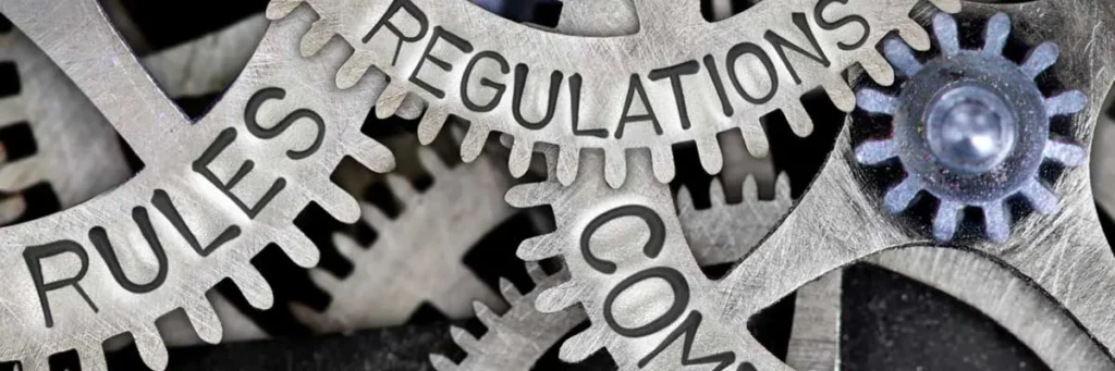 Gears labeled with rules and regulations